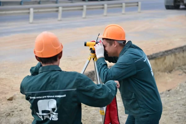 Two men standing next to each other observing a construction site Equipment Operator Training