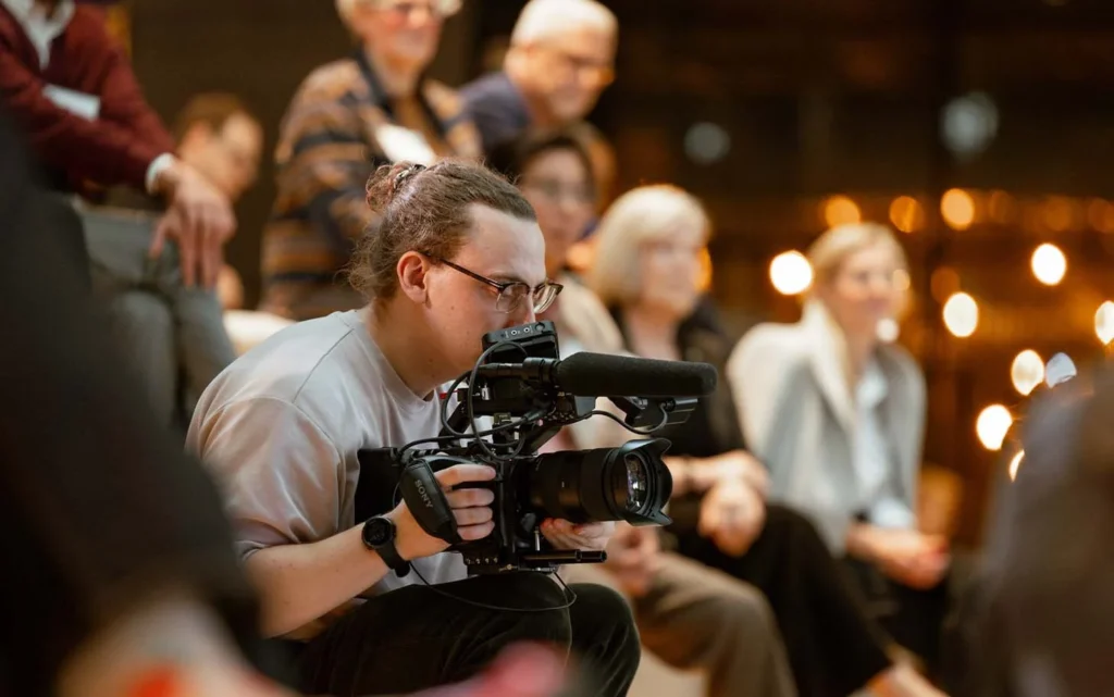 An event videographer in Calgary captures dynamic footage of attendees networking, highlighting the energy of a corporate function.