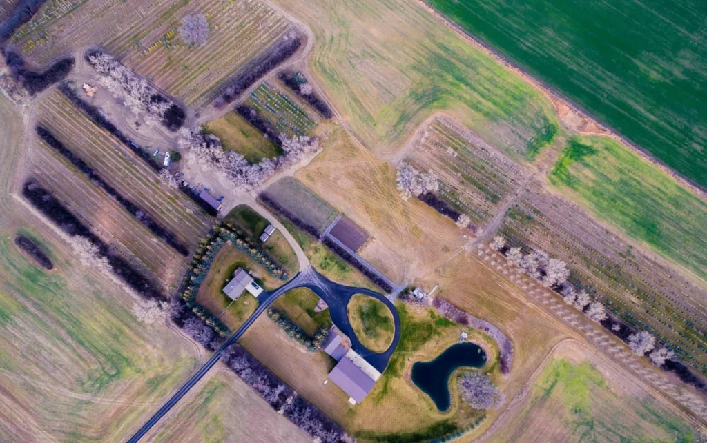 An aerial drone shot over agricultural land in Southern Alberta, highlighting the importance of respecting vast private property and sensitive habitats.