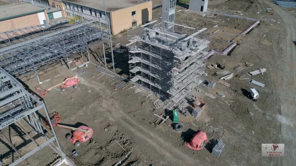 A drone's-eye view showing a construction site progress report, with foundations and structures mapped over time.